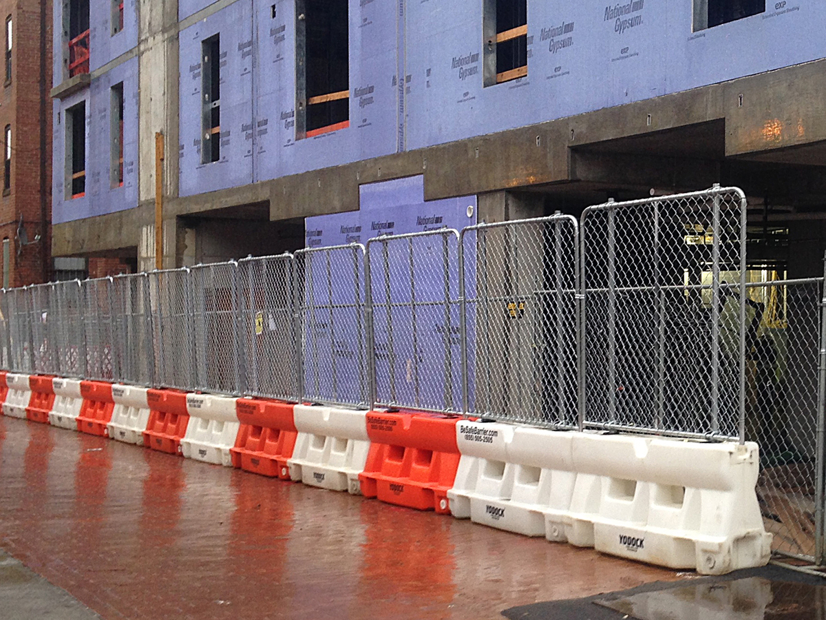 Barriers with fencing at urban construction site