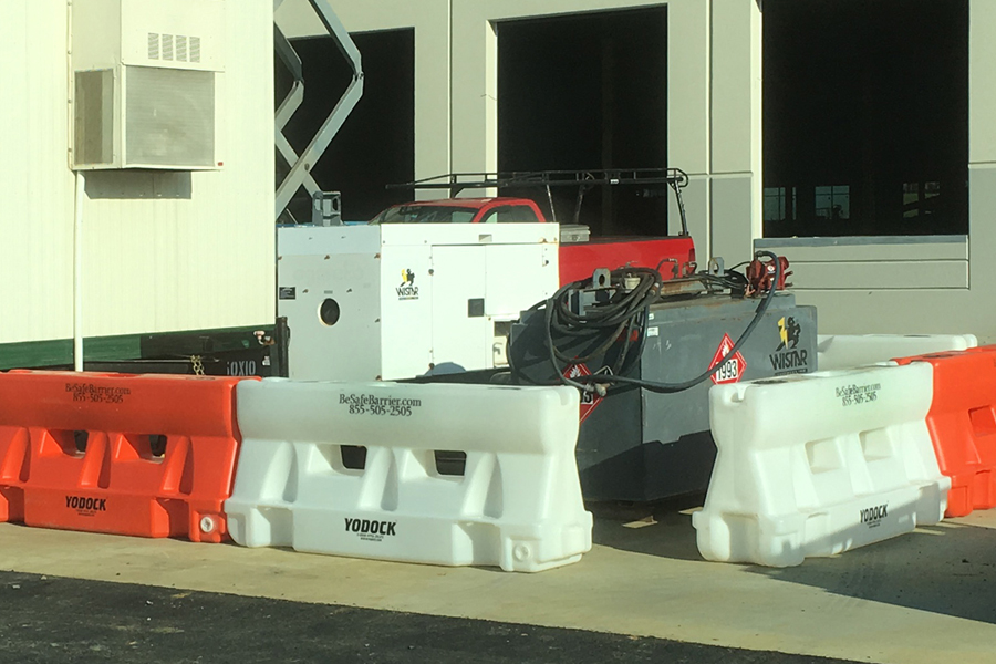 Barriers protect diesel generator at construction site