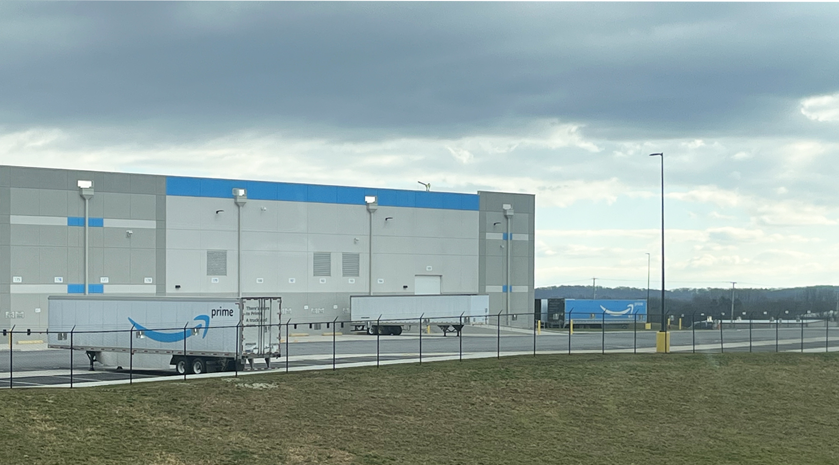 permanent fence installation around Amazon warehouse